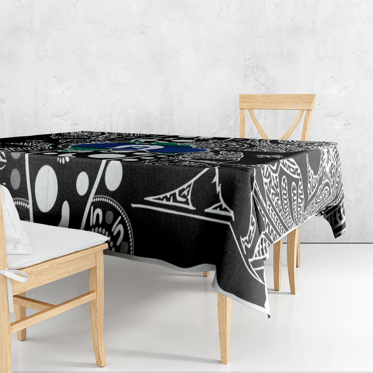 Aboriginal patterned tablecloth with black base, white tribal shapes, and blue-green details