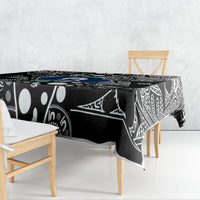 Aboriginal patterned tablecloth with black base, white tribal shapes, and blue-green details