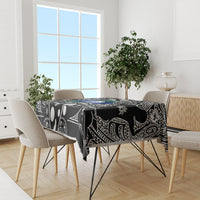 Aboriginal patterned tablecloth in black with white tribal icons and blue-green decorative print