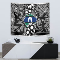 Aboriginal-style tapestry with black-and-white motifs and a blue-green central design
