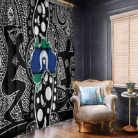 Multicolor map print on black Aboriginal pattern window curtain, hanging at corner