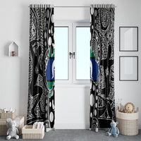 Two hanging black Aboriginal pattern curtains with blue-and-green map accents