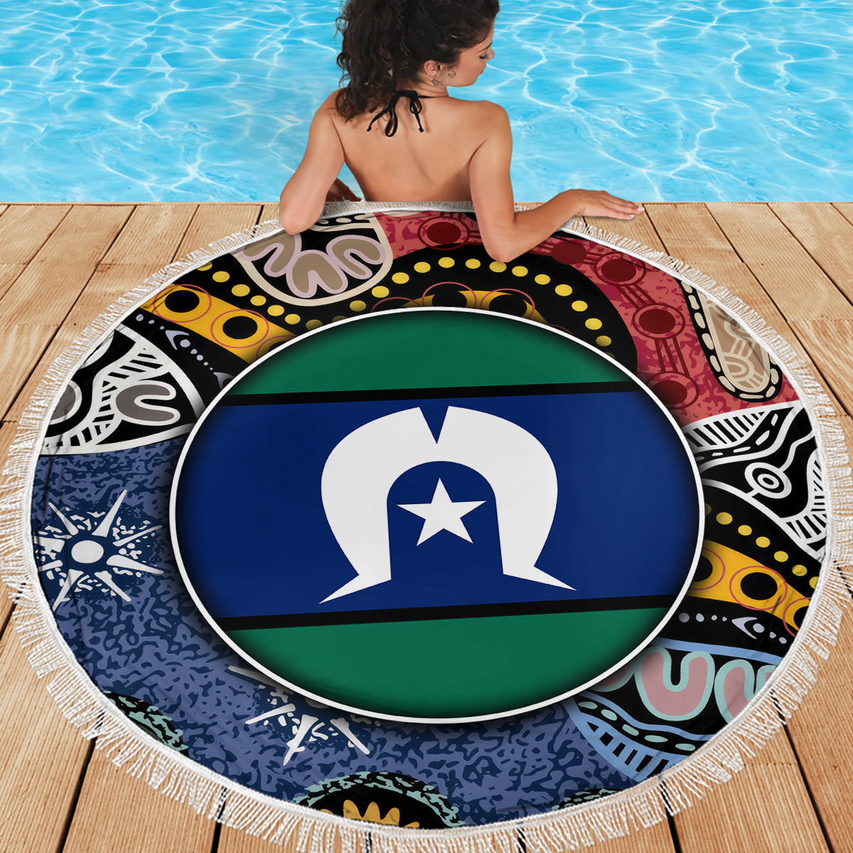 Round beach blanket with circular flag emblem and multicolor pattern, white fringe border