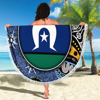 Round beach blanket with navy, green and white flag-style center; fringe edge