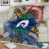 Multicolor aboriginal pattern blanket with circular flag-style emblem, close-up on sofa
