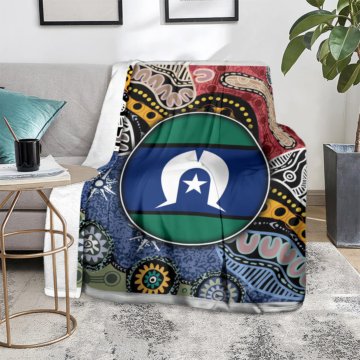 Multicolor aboriginal pattern blanket with circular flag-style emblem, on gray lounge chair