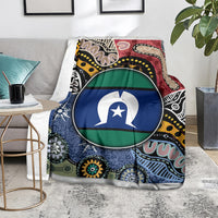 Multicolor aboriginal pattern blanket with circular flag-style emblem, on gray lounge chair
