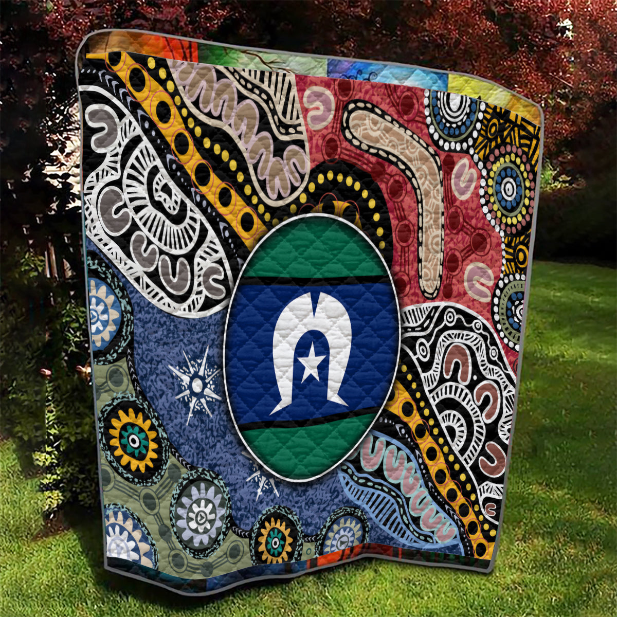 Aboriginal pattern quilt with oval star emblem center, red, blue, yellow tribal print