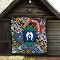 Aboriginal pattern quilt hanging in doorway, oval star emblem with blue and red sections