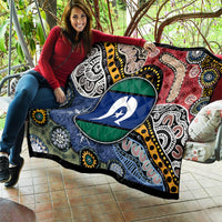 Aboriginal pattern quilt with oval star emblem, multicolor tribal design stretched on couch