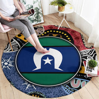 Round area rug being placed; central flag-style emblem in blue and green with multicolor border