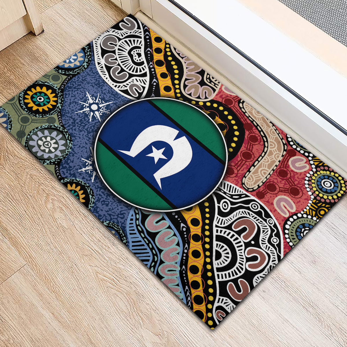 Multicolor rubber doormat with corner view of round emblem and Aboriginal-style swirls