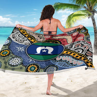 Multicolor patterned sarong worn as beach wrap, large emblem circle on back