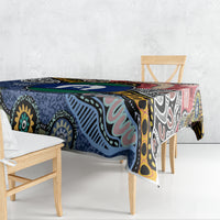 Rectangular tablecloth with multicolor Aboriginal island pattern, draped on dining table corner