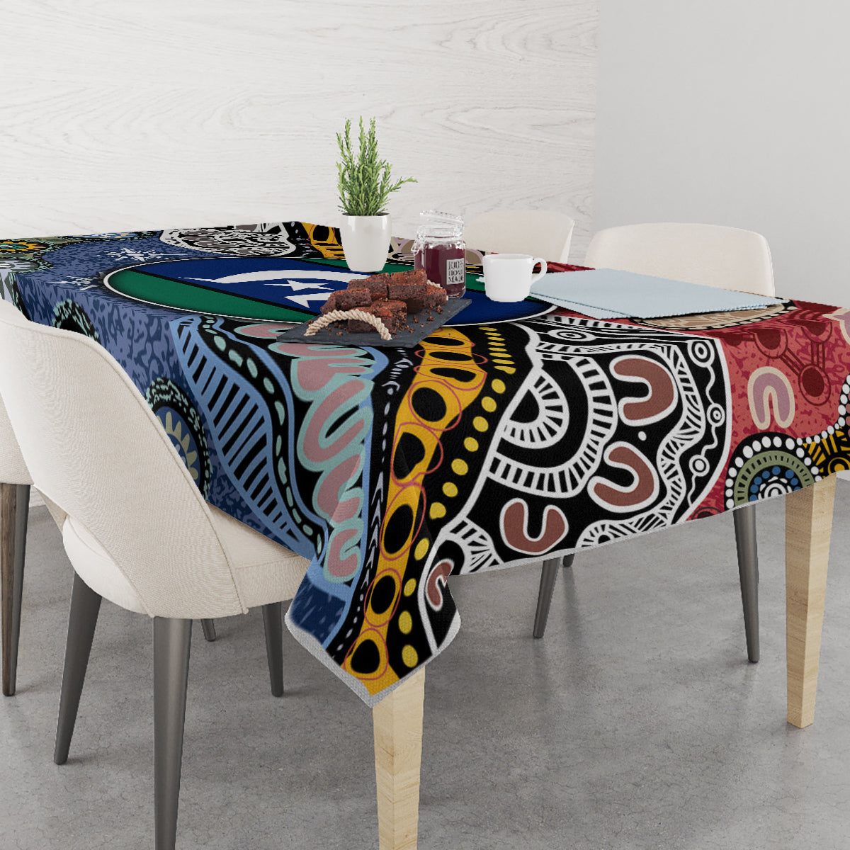Rectangular tablecloth with multicolor Aboriginal pattern on dining table with place settings
