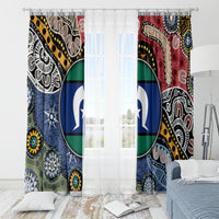Multicolor Aboriginal curtain pair with large circular blue emblem behind sheer light