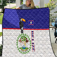 Blue and white quilt with quilted pattern, toucan, and Belize flag emblem print