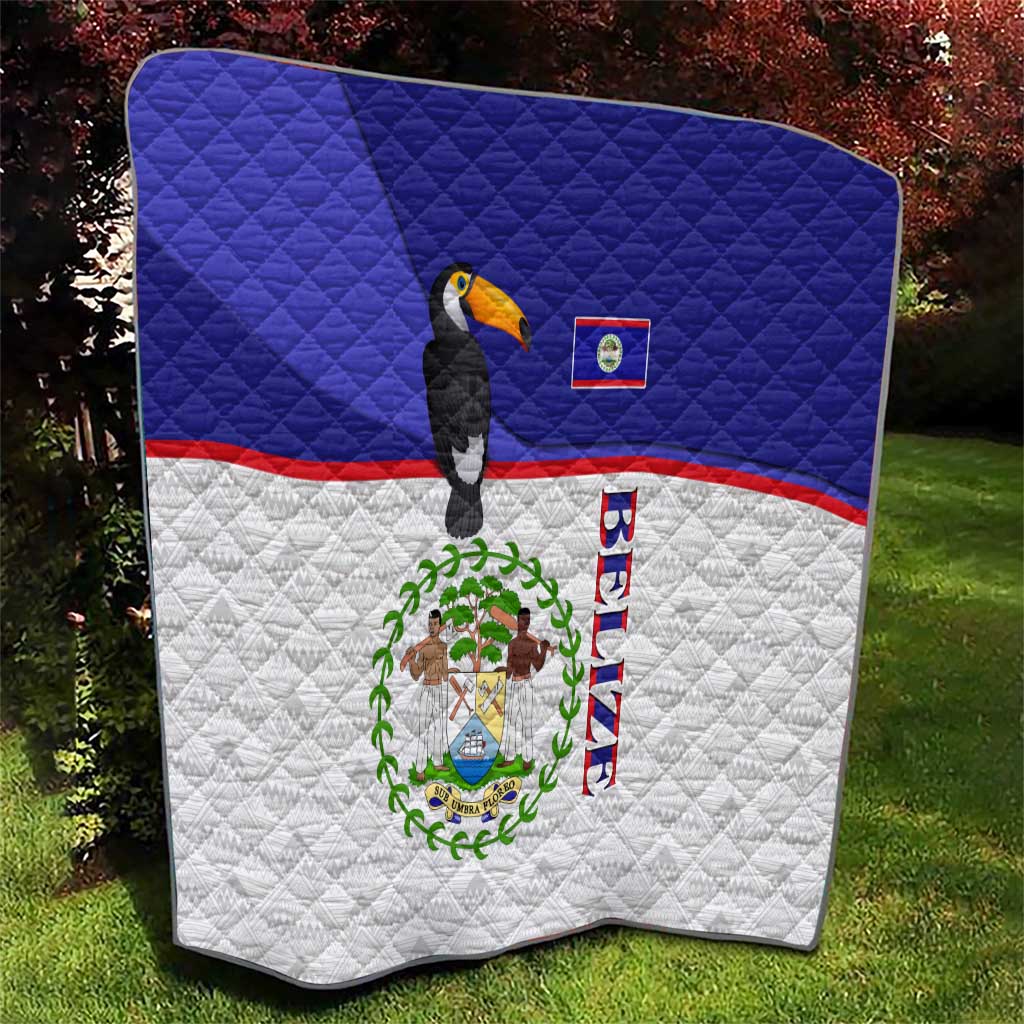 Blue and white quilt with diagonal flag stripes, toucan, and Belize emblem center