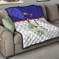 Blue and white throw quilt on sofa showing toucan print and Belize coat of arms