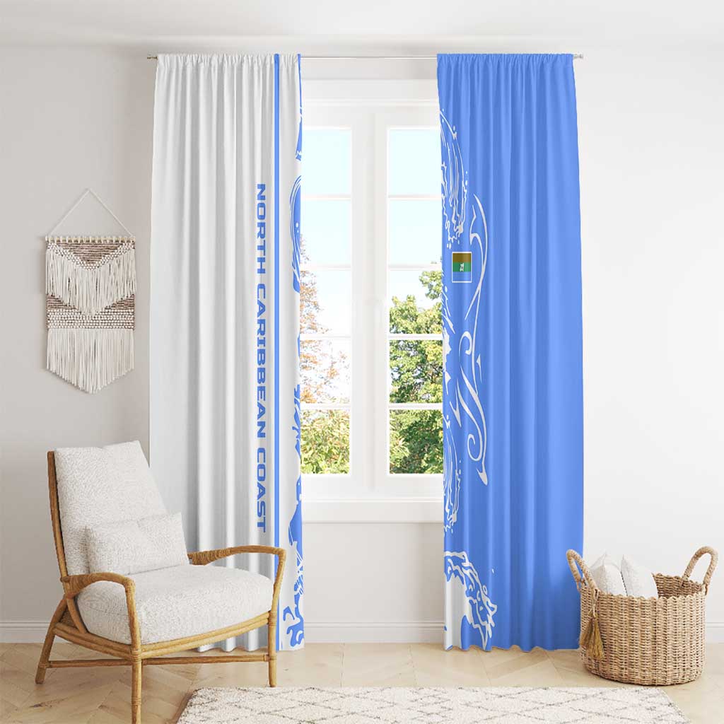 Blue and white wave-pattern window curtains hanging side by side over a window.