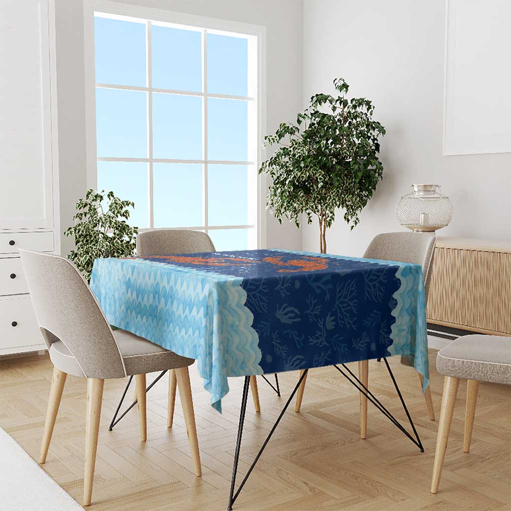 Blue ocean-wave tablecloth with red crab coral reef print, draped on dining table