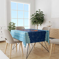 Blue ocean-wave tablecloth with red crab coral reef print, draped on dining table