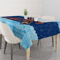 Blue tablecloth with ocean-wave border and red crab coral reef artwork, side view