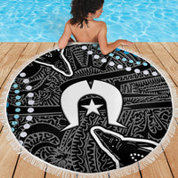 Round fringed beach blanket with bold black-and-white tribal graphic and blue accents