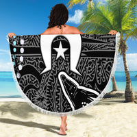 Fringed round beach blanket with black-and-white tribal design and central star emblem