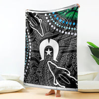 Aboriginal pattern blanket with whale-like figures, star emblem, and blue dot accents