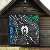 Multicolor quilt hanging on a porch with black-and-white central figure, star, and blue trim