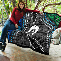 Multicolor quilt held up by a person, black design with white figure, star, blue circles