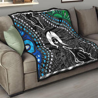Multicolor decorative quilt on a sofa with black base, white figure, star, blue and green accents
