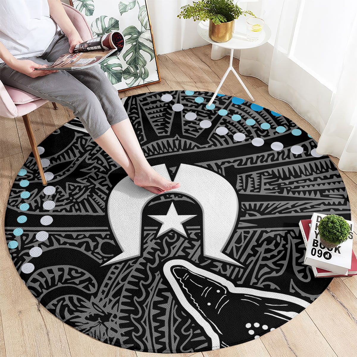 Round patterned carpet with bold black, white/gray motifs and scattered light blue dots