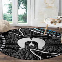 Round tribal carpet design in black with white and gray emblem and subtle blue highlights