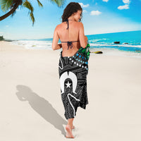 Black and white sarong with large whale graphic, star emblem, and abstract border lines