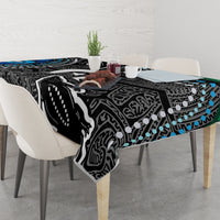Black and white tablecloth with teal dots, spread across a dining table surface.