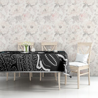 Black, white, and teal tablecloth featuring abstract Aboriginal-inspired line and dot motifs.