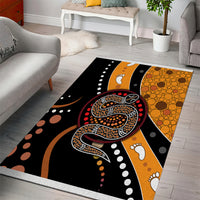 Multicolor snake dot art area rug, featuring a central patterned serpent on black and orange.