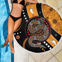 Round beach blanket close-up: fringed edge with Aboriginal snake dot art and paw motifs