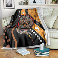 Multicolor snake dot art blanket draped over bed with wavy patterned print.