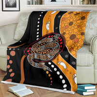 Multicolor snake dot art blanket draped on couch, featuring orange bubble patterns.