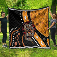 Oversized snake dot art quilt featuring black and orange panels with paw-print details