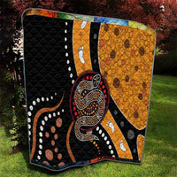 Quilt with bold snake figure in black, orange, red, and white, plus dot and paw motifs