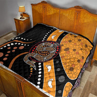 Bed quilt with black backing, orange dot pattern, and central snake artwork with paw prints