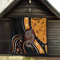 Front view of snake-pattern quilt in black and orange with dotwork, paw prints, and edging