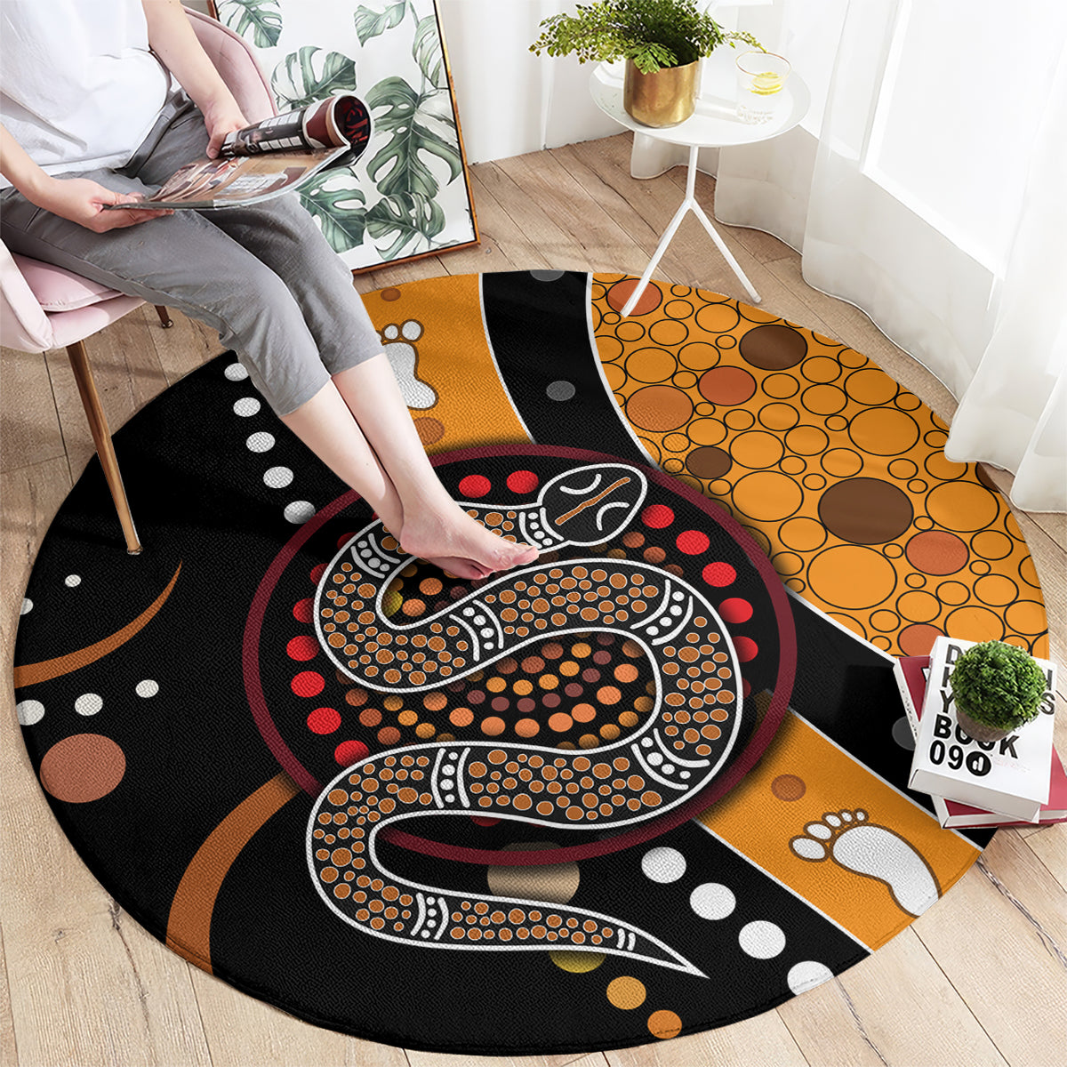 Round area rug with Aboriginal snake dot art, orange and black with red and white accents