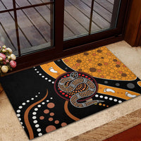 Multicolor outdoor doormat with coiled snake motif and orange dot circles on black background