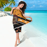 Orange and black dot-art snake sarong, draped and partially wrapped around the body.