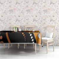 Multicolor snake dot art tablecloth on table, black and orange pattern with paw and dot motifs